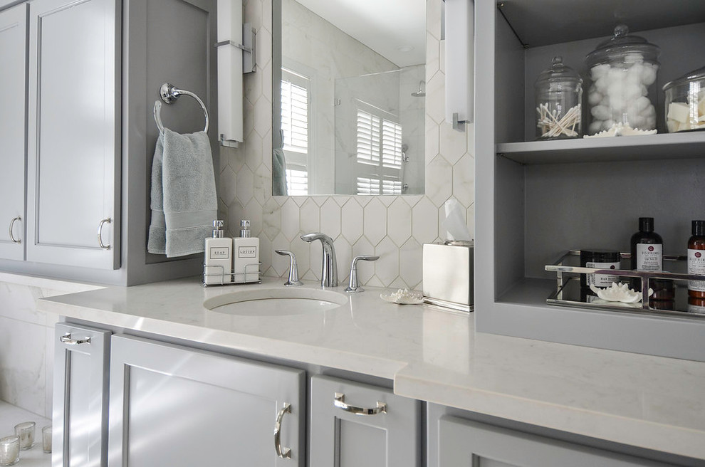 Mid-sized transitional master bathroom in Atlanta with an undermount sink, recessed-panel cabinets, grey cabinets, engineered quartz benchtops, a drop-in tub, a corner shower, white tile, porcelain tile, white walls and porcelain floors.