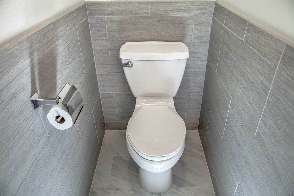 Design ideas for a mid-sized transitional master bathroom in Phoenix with flat-panel cabinets, brown cabinets, a curbless shower, a one-piece toilet, gray tile, porcelain tile, beige walls, porcelain floors, an undermount sink, engineered quartz benchtops, grey floor and an open shower.
