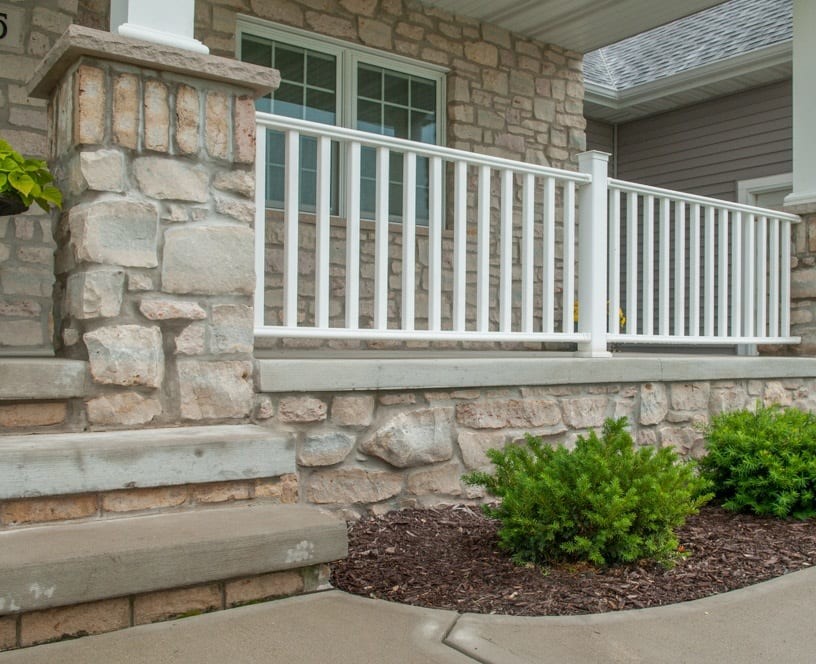 Photo of an arts and crafts front yard verandah in Milwaukee with a roof extension and concrete slab.