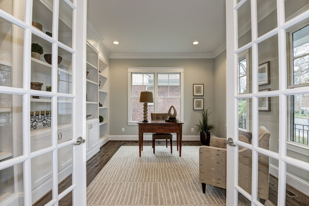 Design ideas for a mid-sized arts and crafts study room in DC Metro with grey walls, dark hardwood floors and a freestanding desk.