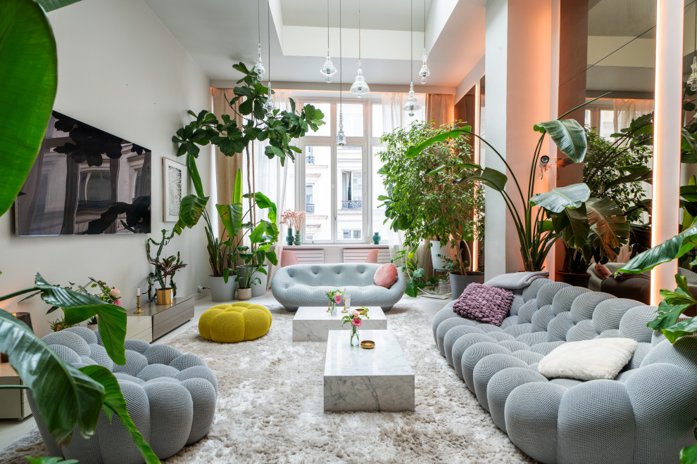 Design ideas for a large eclectic grey and pink living room in Paris with white walls, painted wood flooring, no fireplace, a wall mounted tv, white floors and feature lighting.