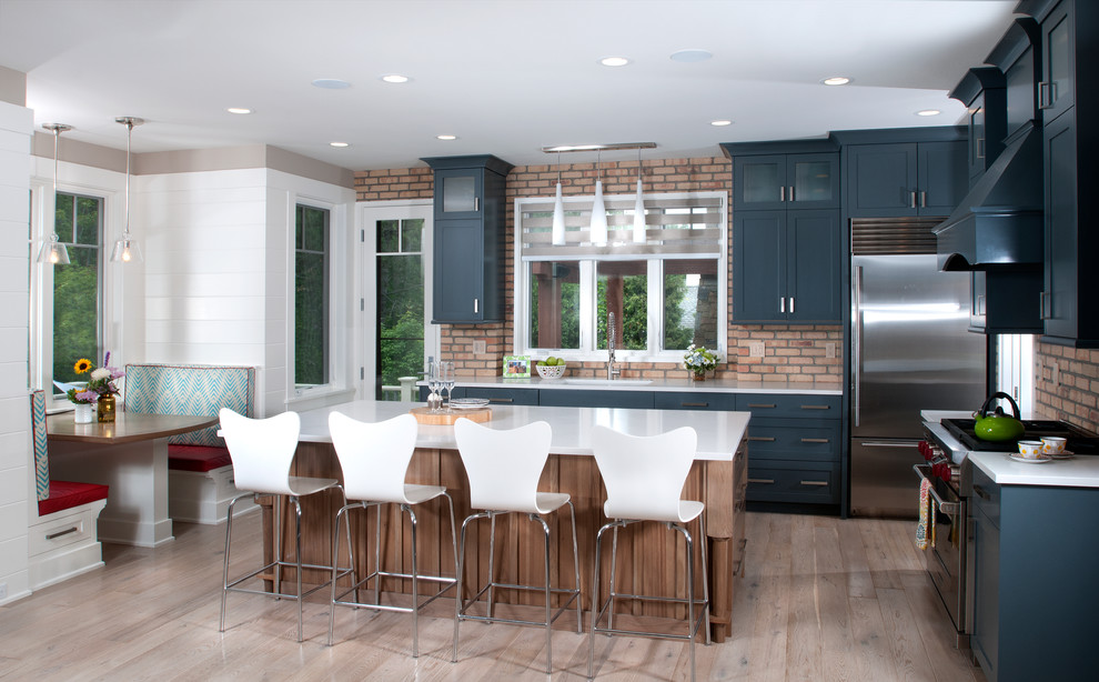 Inspiration for a contemporary l-shaped eat-in kitchen in Grand Rapids with shaker cabinets, blue cabinets, medium hardwood floors and with island.