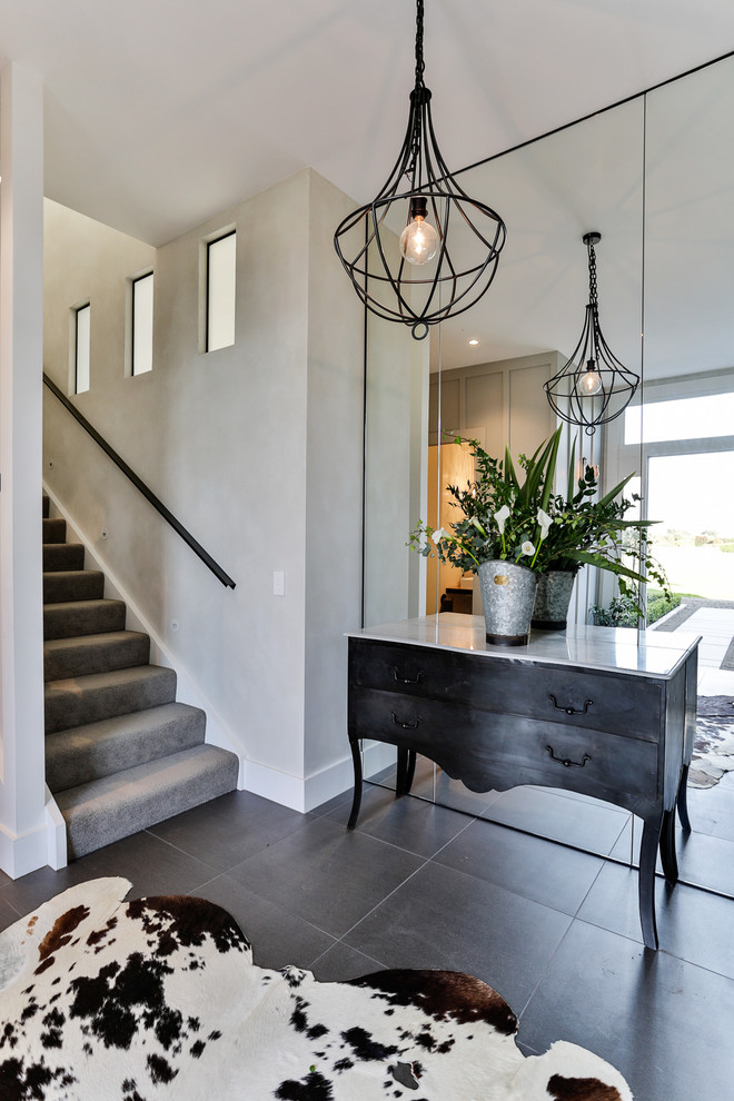Photo of a transitional foyer in Auckland with grey walls.