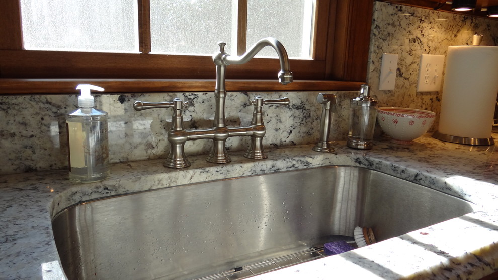 White eyes granite with full height granite backsplash Traditional