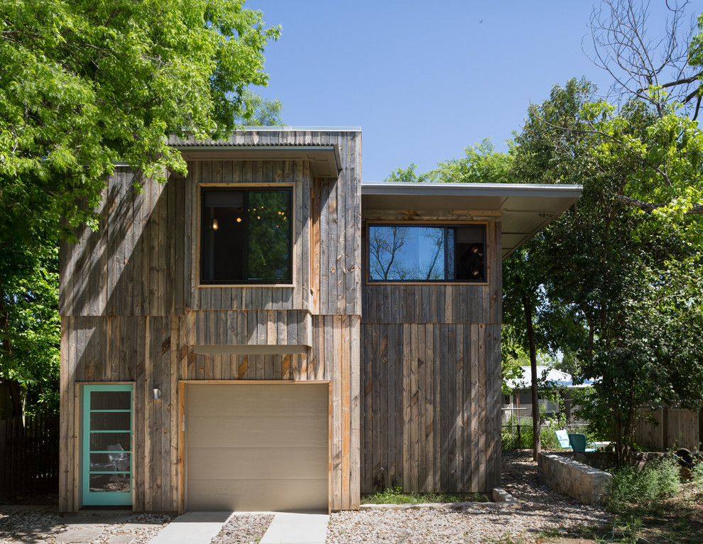 Design ideas for a small contemporary exterior in Austin with wood siding and a flat roof.