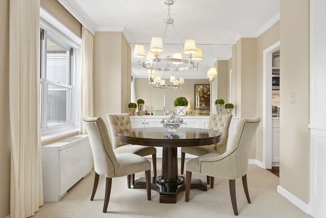 Photo of a small transitional separate dining room in New York with beige walls, carpet and no fireplace.