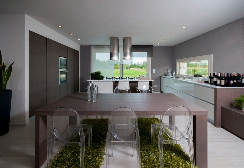This is an example of a large contemporary single-wall eat-in kitchen in Venice with a drop-in sink, flat-panel cabinets, dark wood cabinets, solid surface benchtops, glass sheet splashback, stainless steel appliances and with island.