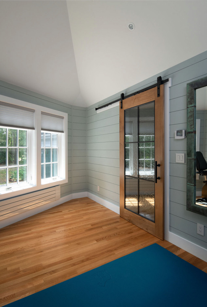 This is an example of a large transitional home gym in Boston.