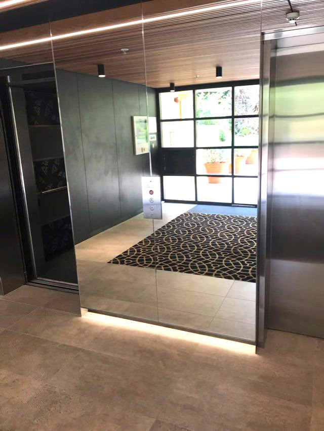 This is an example of a modern foyer in Sydney with a glass front door.