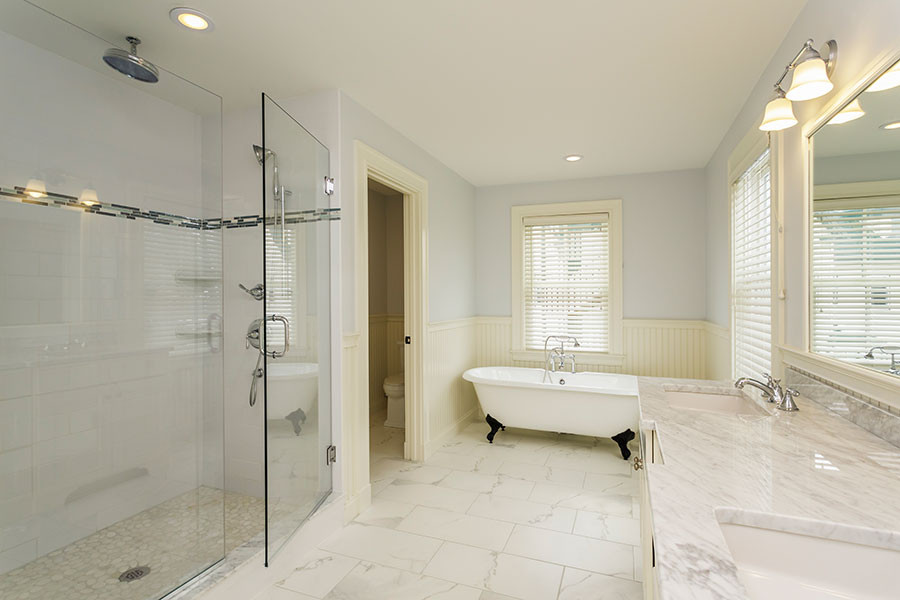 Inspiration for a large ensuite wet room bathroom in San Francisco with shaker cabinets, white cabinets, marble worktops, double sinks, a built in vanity unit, a claw-foot bath, a two-piece toilet, grey walls, porcelain flooring, a submerged sink, white floors, a hinged door and a dado rail.