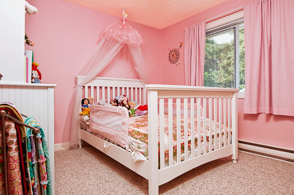 Photo of a contemporary kids' room for girls in Vancouver with pink walls.