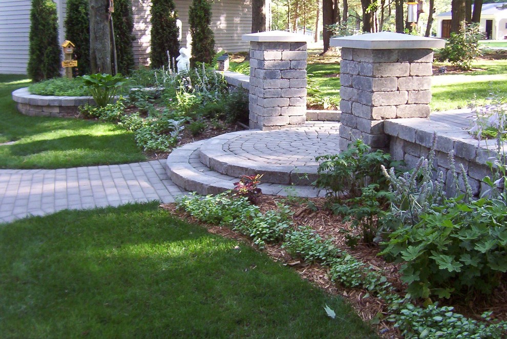 Small transitional front yard partial sun garden in Other with a garden path and concrete pavers.