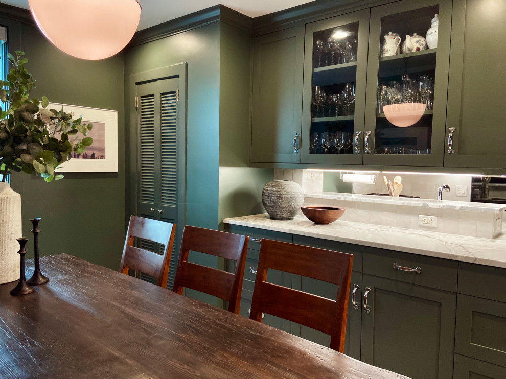 Mid-sized transitional l-shaped marble floor and beige floor enclosed kitchen photo with an undermount sink, shaker cabinets, green cabinets, quartzite countertops, white backsplash, ceramic backsplash, stainless steel appliances, a peninsula and gray countertops