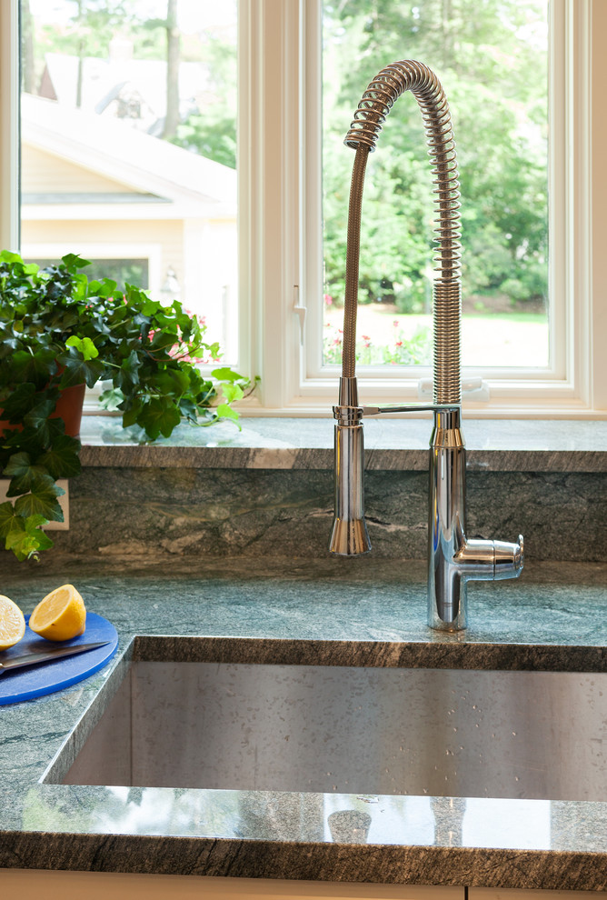 Example of a large transitional galley medium tone wood floor open concept kitchen design in Boston with an undermount sink, shaker cabinets, white cabinets, granite countertops, multicolored backsplash, stone slab backsplash, stainless steel appliances and a peninsula