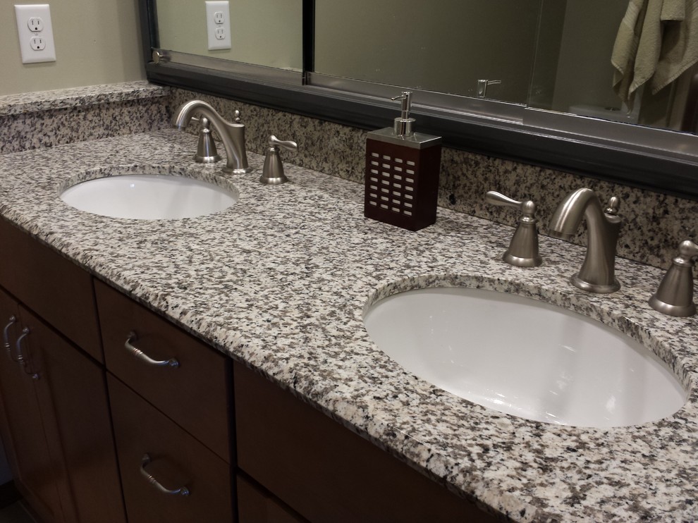 Modern bathroom in Cedar Rapids with an undermount sink, shaker cabinets, medium wood cabinets and granite benchtops.