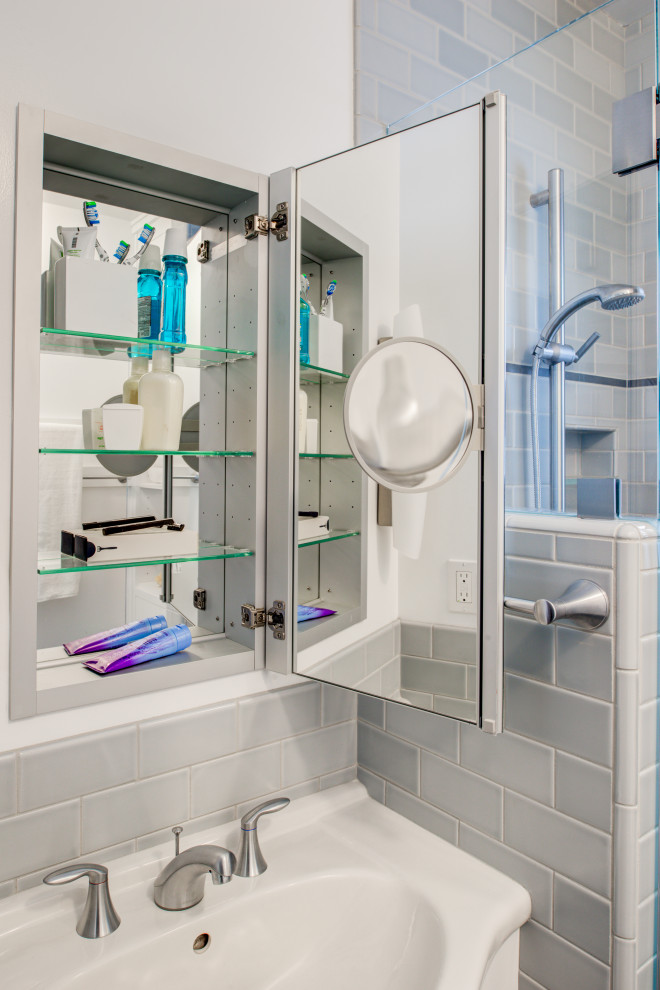 Small transitional blue tile and ceramic tile porcelain tile, blue floor and single-sink bathroom photo in San Francisco with flat-panel cabinets, white cabinets, a wall-mount toilet, white walls, an integrated sink, solid surface countertops, white countertops, a niche and a built-in vanity