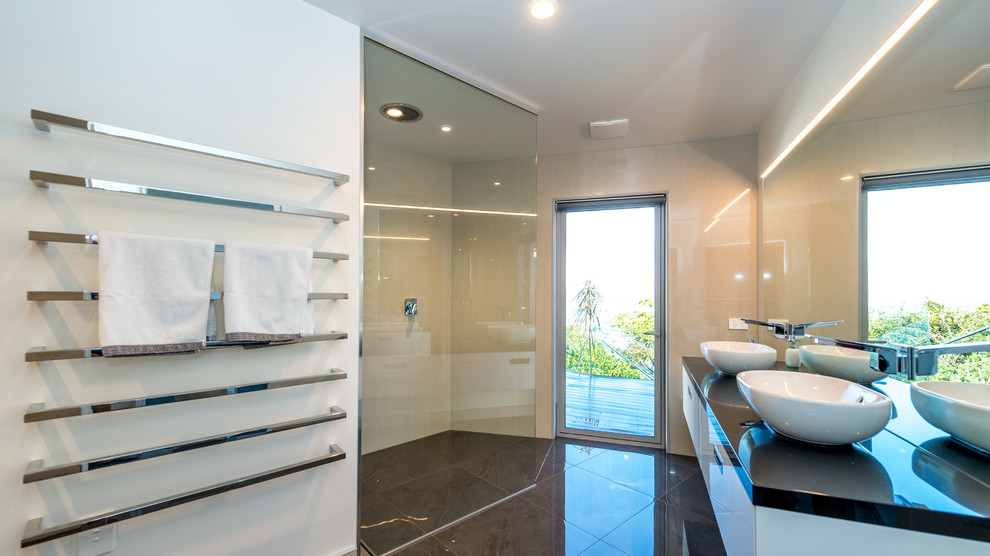 Inspiration for a mid-sized modern bathroom in Other with a wall-mount sink, an alcove tub, a curbless shower, a one-piece toilet, white walls and ceramic floors.