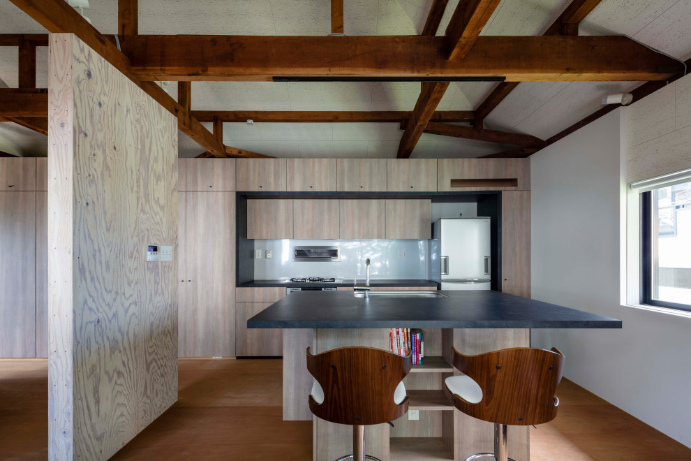 Inspiration for a small modern galley eat-in kitchen in Kobe with a single-bowl sink, beaded inset cabinets, light wood cabinets, solid surface benchtops, white splashback, glass sheet splashback, stainless steel appliances, plywood floors, with island, brown floor, black benchtop and exposed beam.