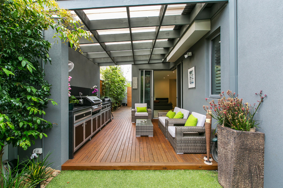 Contemporary patio in Melbourne with an outdoor kitchen, decking and a pergola.