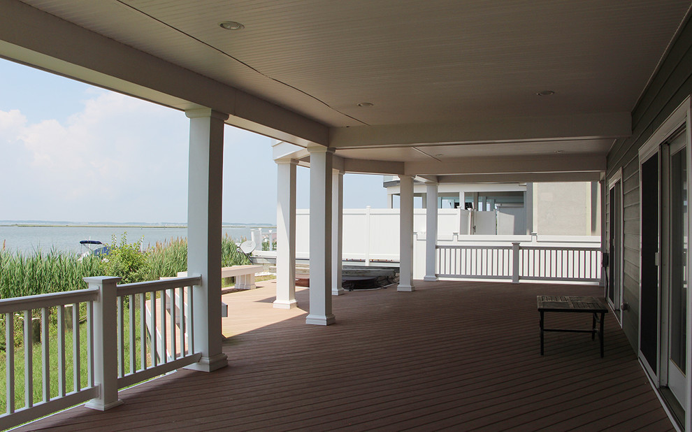 This is an example of an expansive beach style backyard verandah in Other.