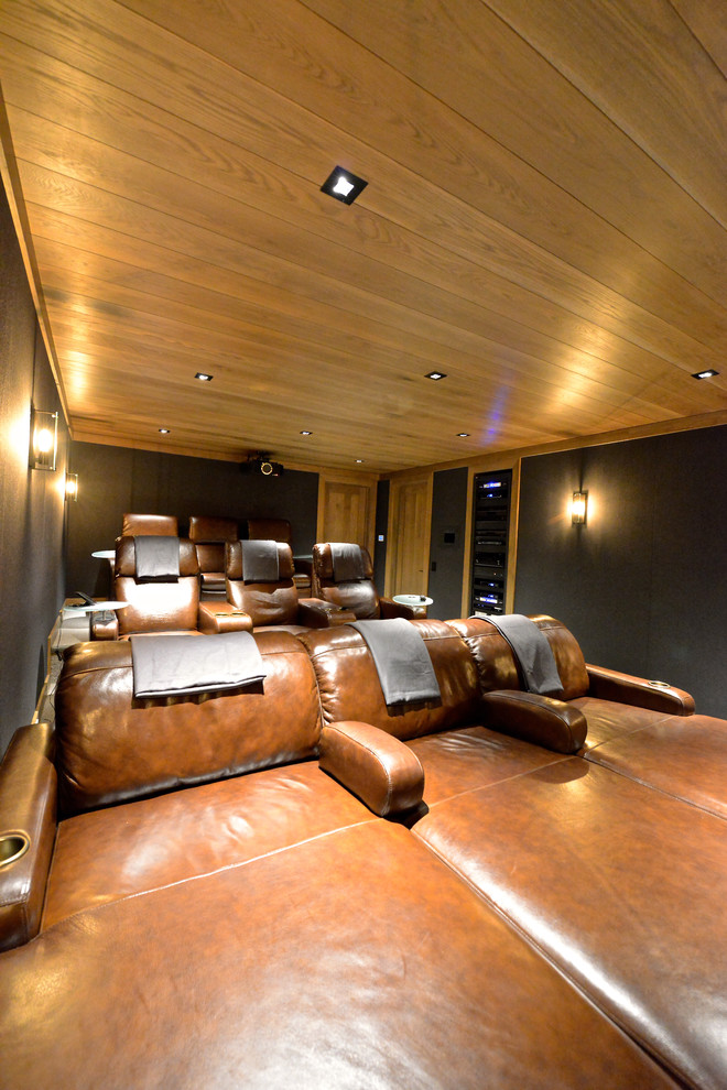 Large transitional enclosed home theatre in Boise with brown walls, carpet and a projector screen.