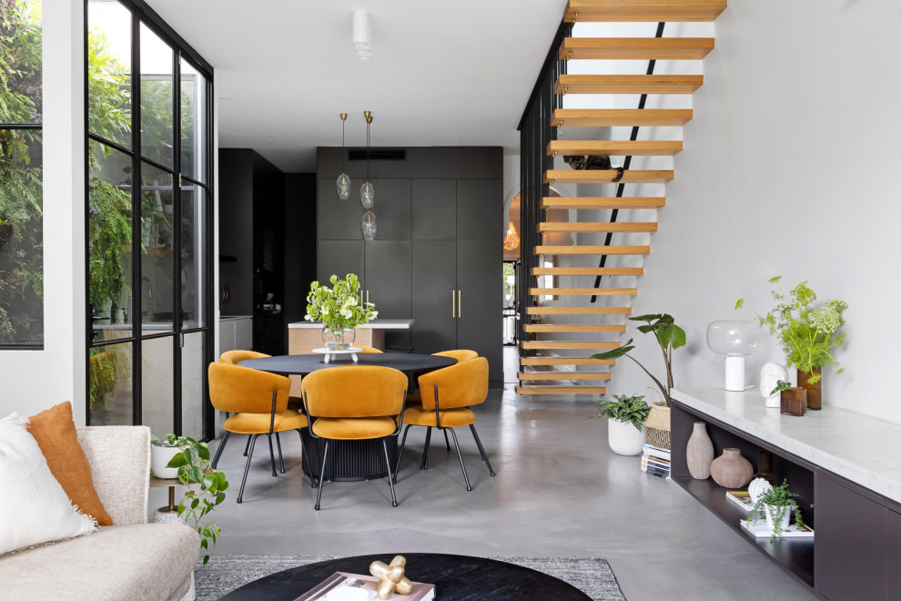 This is an example of a contemporary dining room in Melbourne.
