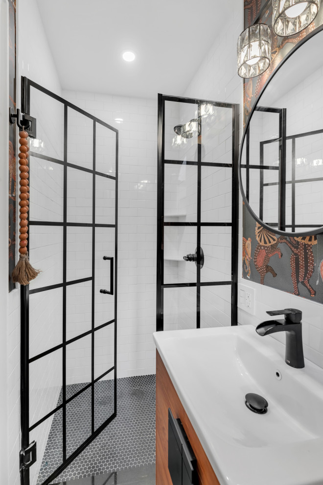 Medium sized romantic ensuite bathroom in New York with flat-panel cabinets, brown cabinets, an alcove shower, multi-coloured tiles, ceramic tiles, ceramic flooring, quartz worktops, black floors, a hinged door, white worktops, a single sink, a floating vanity unit and wallpapered walls.