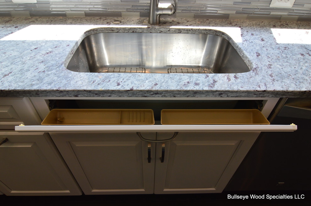 Inspiration for a large transitional u-shaped dark wood floor and brown floor eat-in kitchen remodel in DC Metro with an undermount sink, raised-panel cabinets, white cabinets, granite countertops, gray backsplash, glass tile backsplash, stainless steel appliances and an island