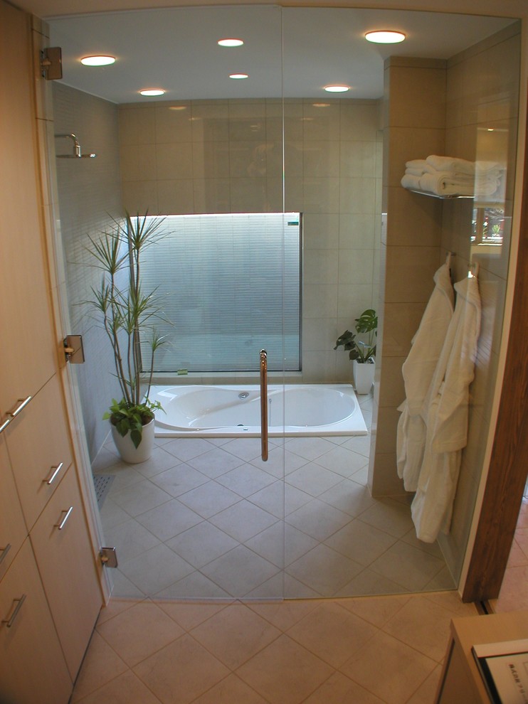 Inspiration for an asian bathroom in Other with flat-panel cabinets and a drop-in tub.