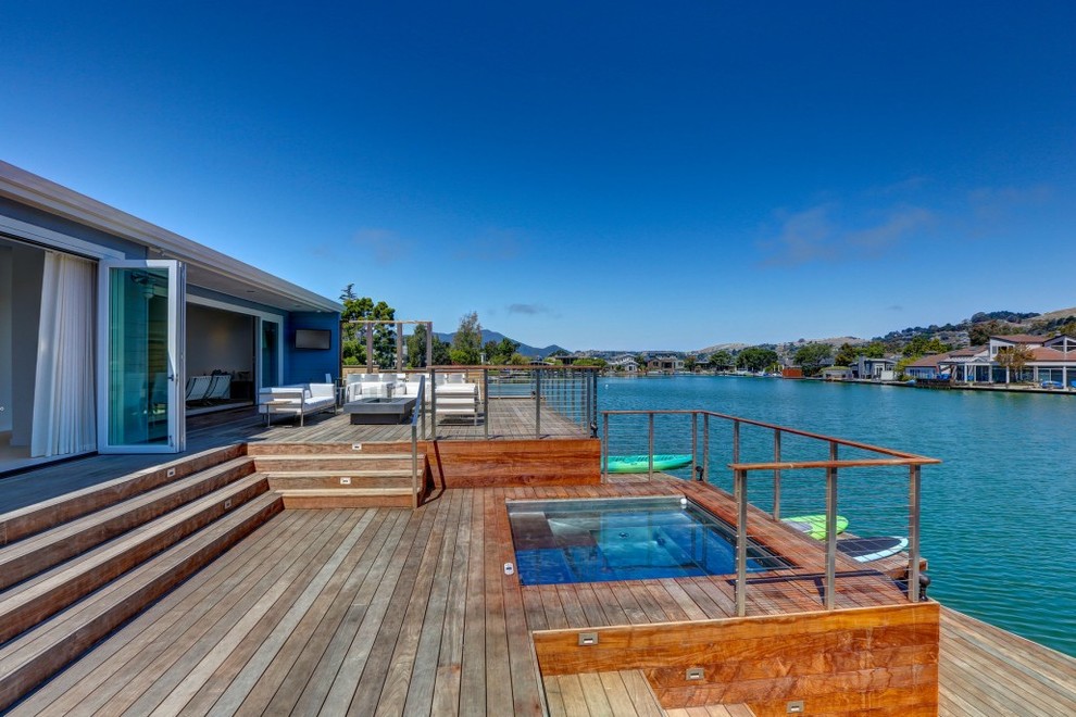 This is an example of a large contemporary backyard deck in San Francisco with with dock and no cover.