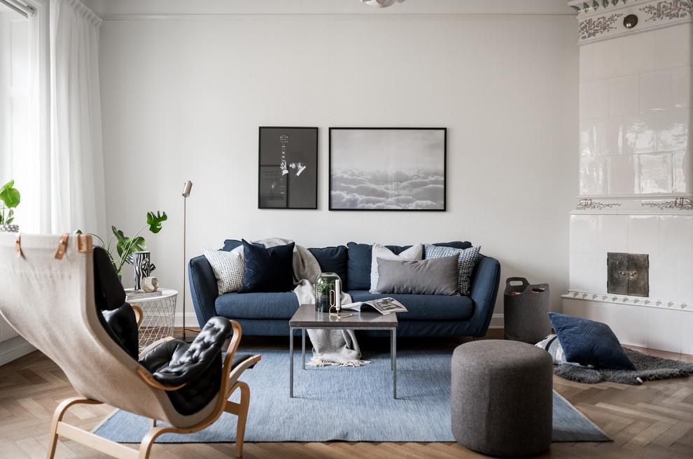 Scandinavian formal enclosed living room in Stockholm with white walls, medium hardwood floors and beige floor.