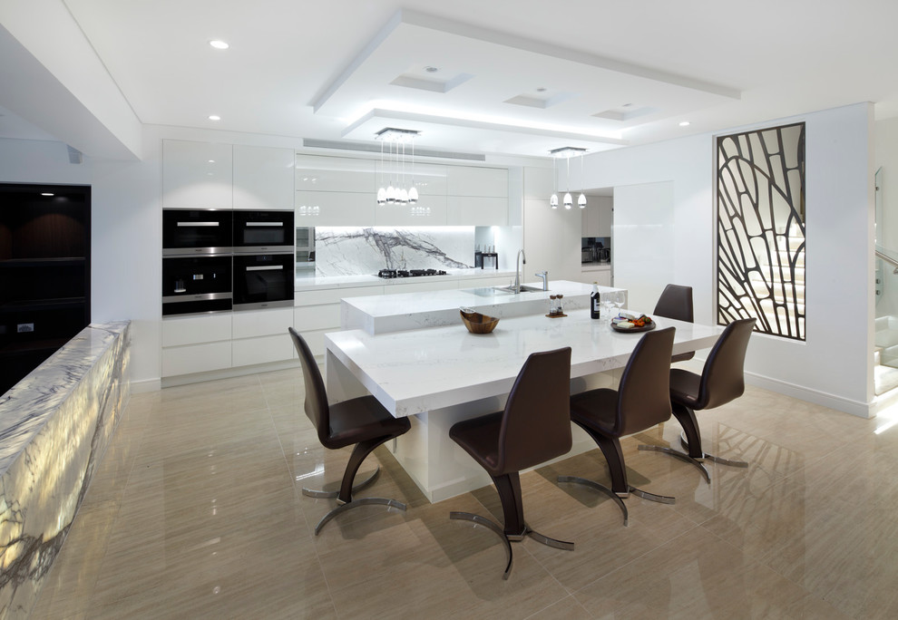 This is an example of a contemporary galley eat-in kitchen in Sydney with flat-panel cabinets, white cabinets, white splashback, stone slab splashback, black appliances and with island.