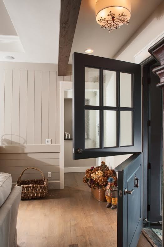 Inspiration for a large rustic ceramic tile front door remodel in Denver with beige walls and a black front door