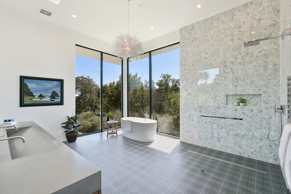 Inspiration for a large contemporary master bathroom in Los Angeles with a freestanding tub, white tile, mosaic tile, white walls, a trough sink, grey floor, grey benchtops, an open shower, solid surface benchtops and an open shower.