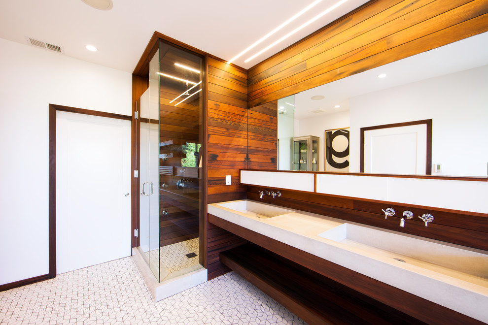 Mid-sized modern master bathroom in San Francisco with an integrated sink, distressed cabinets, concrete benchtops, a drop-in tub, a corner shower, a wall-mount toilet, white tile, ceramic tile, white walls and ceramic floors.