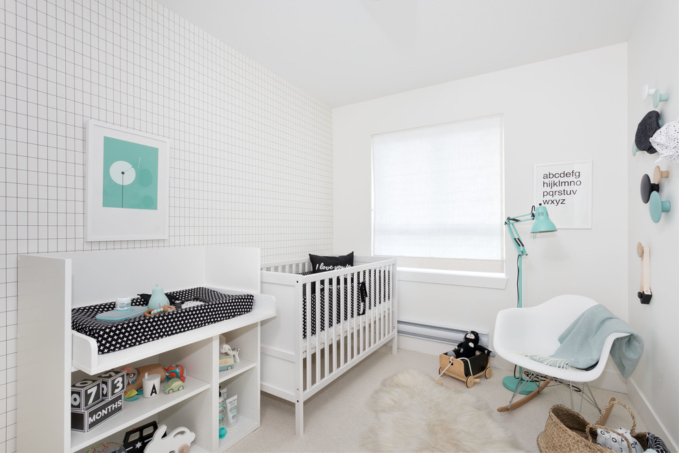 This is an example of a small scandinavian nursery for boys in Vancouver with white walls, carpet and beige floor.