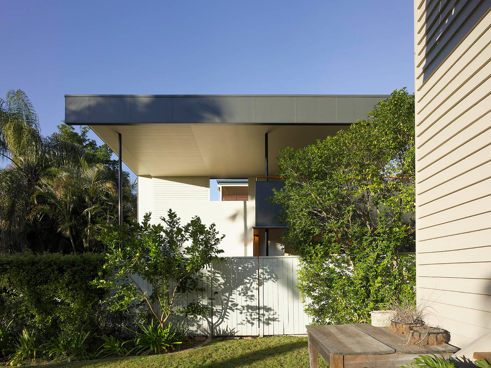 Inspiration for a contemporary two-storey white exterior in Brisbane with wood siding.