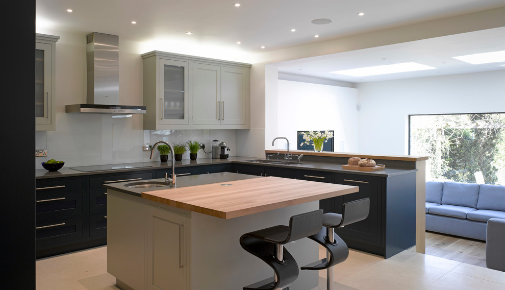 Inspiration for a large contemporary open plan kitchen in London with recessed-panel cabinets, blue cabinets and with island.