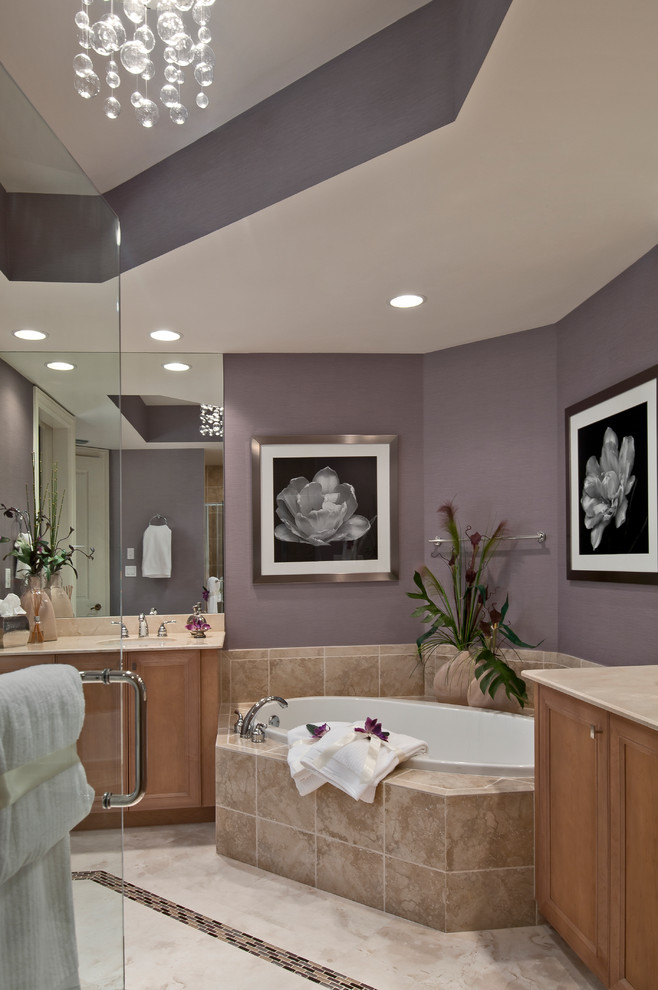 Inspiration for a contemporary bathroom in Miami with recessed-panel cabinets, medium wood cabinets, beige tile, purple walls and a drop-in tub.