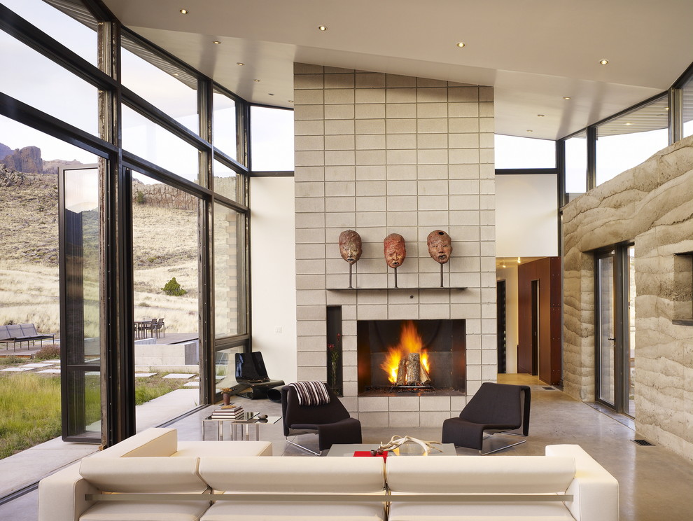 Design ideas for a contemporary formal living room in San Francisco with beige walls, concrete floors, a tile fireplace surround and no tv.