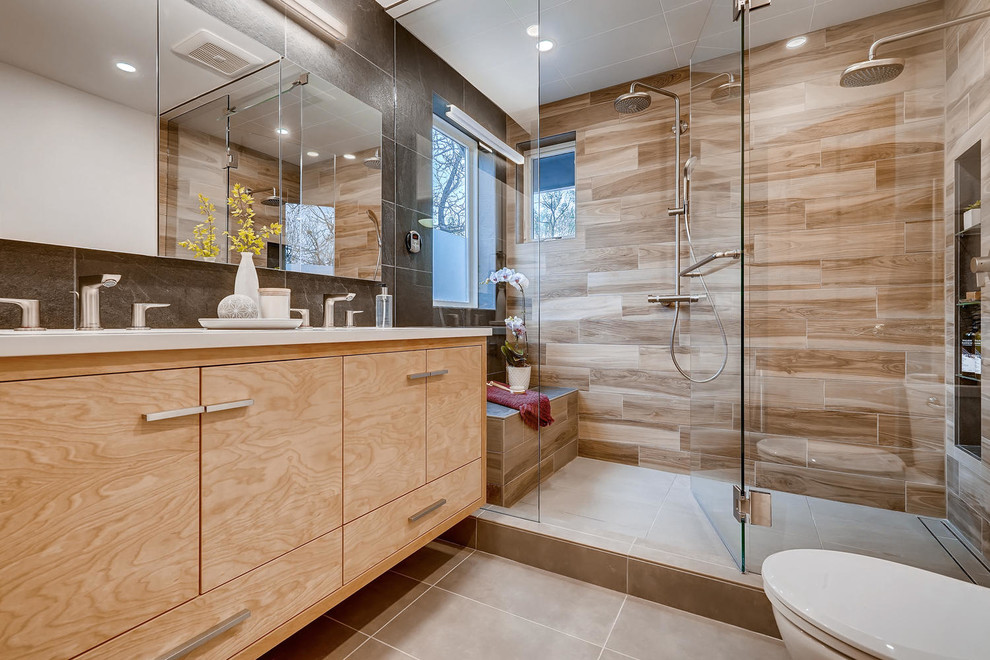 This is an example of a small modern master bathroom in Denver with light wood cabinets, a double shower, a two-piece toilet, brown tile, ceramic tile, ceramic floors, an undermount sink, beige floor, a hinged shower door, white benchtops, flat-panel cabinets, quartzite benchtops and beige walls.