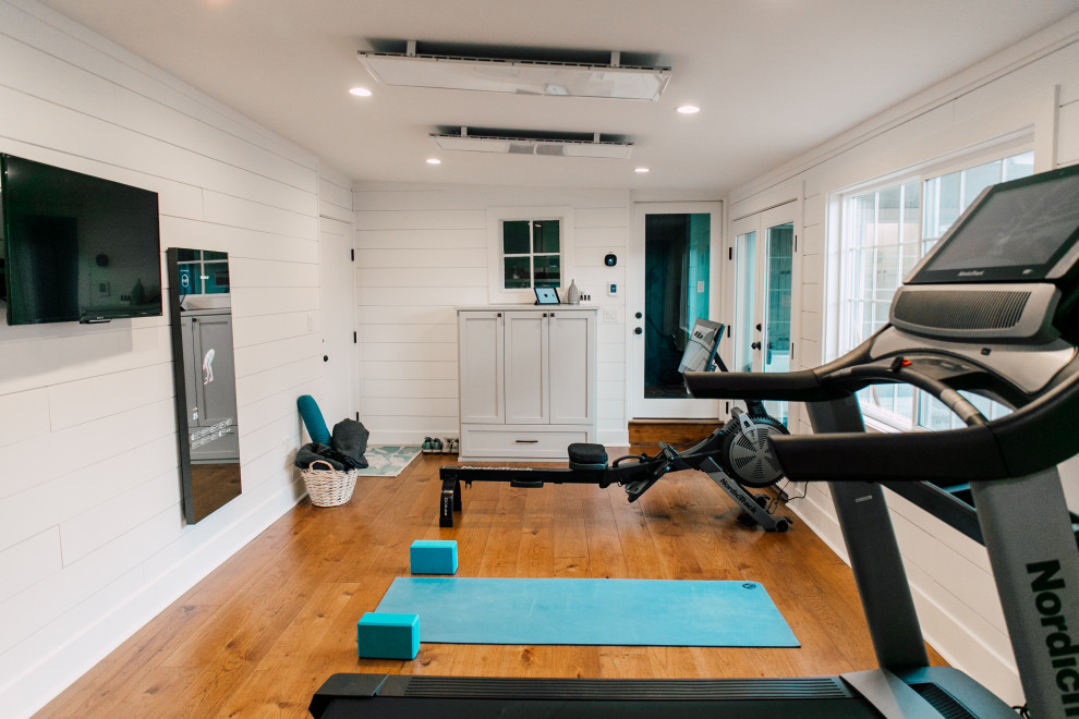 Mid-sized eclectic multipurpose gym in Seattle with white walls, medium hardwood floors, brown floor and vaulted.