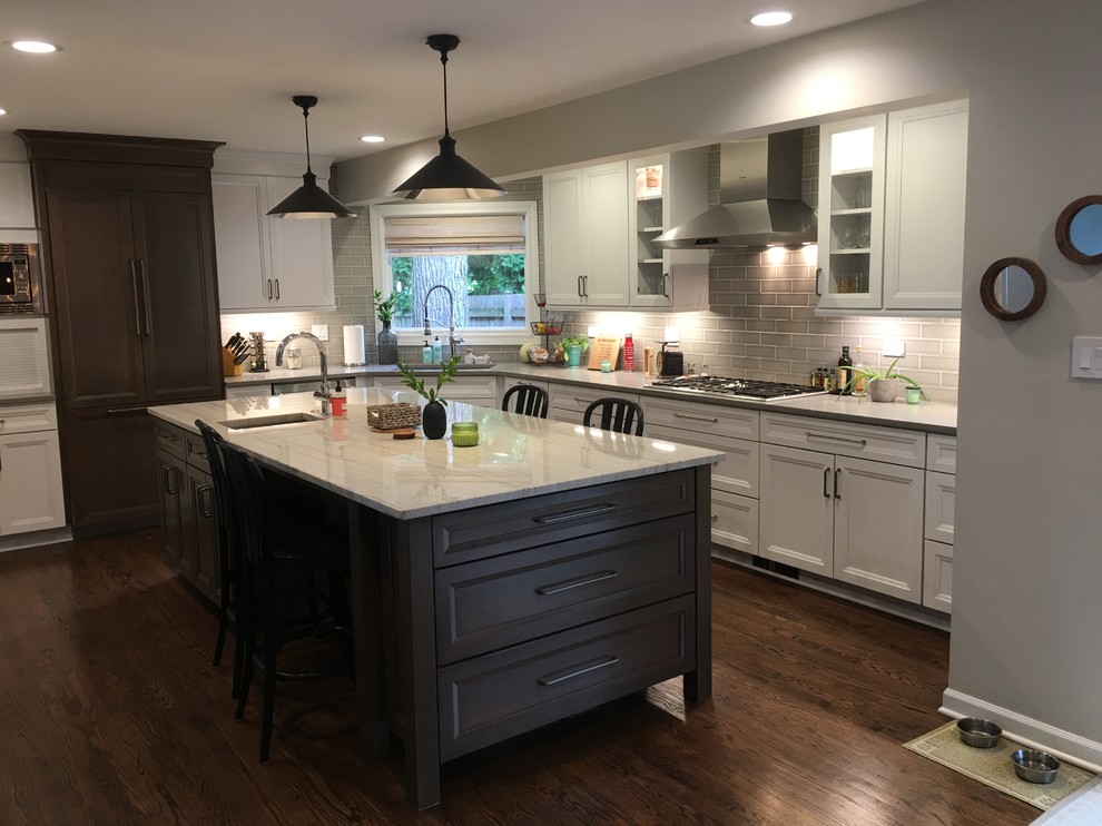 Open concept kitchen - large transitional u-shaped dark wood floor and brown floor open concept kitchen idea in Chicago with an undermount sink, flat-panel cabinets, white cabinets, quartz countertops, gray backsplash, ceramic backsplash, stainless steel appliances, an island and gray countertops