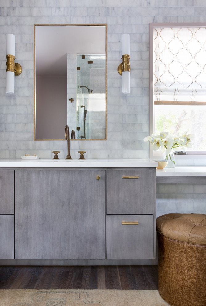 Inspiration for a mid-sized transitional master bathroom in Austin with flat-panel cabinets, grey cabinets, gray tile, solid surface benchtops, white benchtops, grey walls, dark hardwood floors and marble.