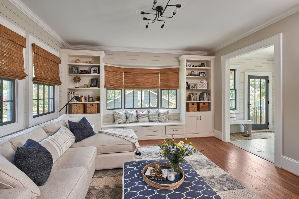 Inspiration for a mid-sized cottage enclosed medium tone wood floor, brown floor and shiplap wall family room remodel in Charlotte with beige walls and no fireplace