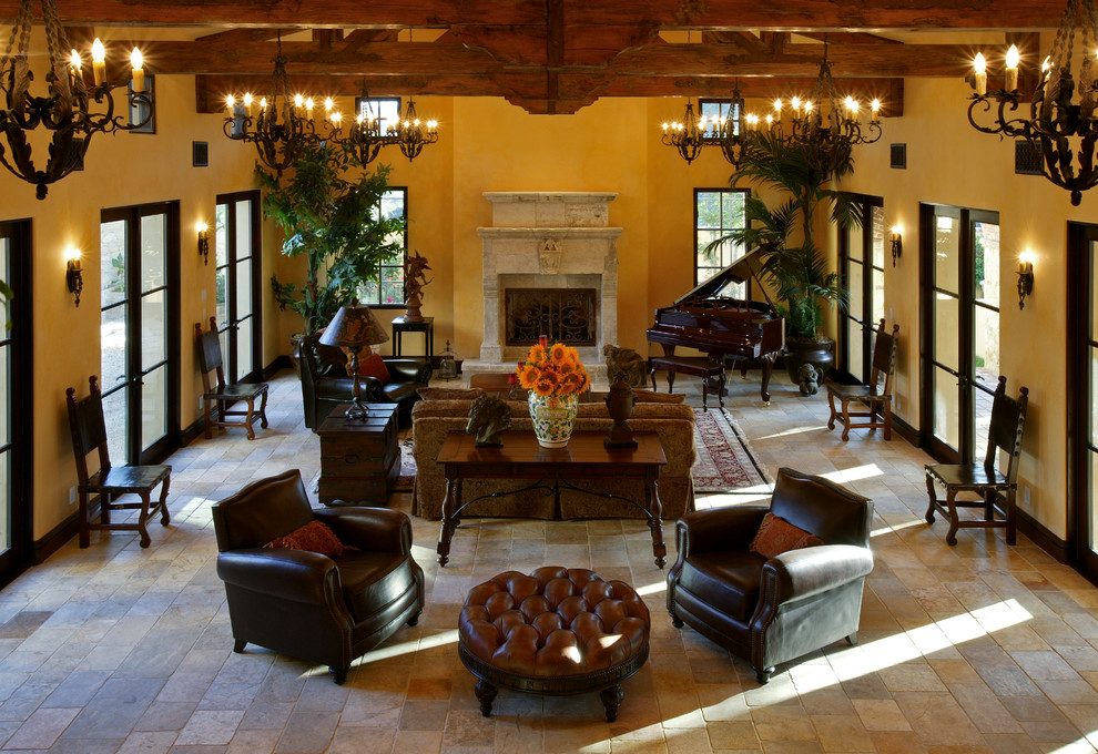 This is an example of a country living room in Orange County with a stone fireplace surround.