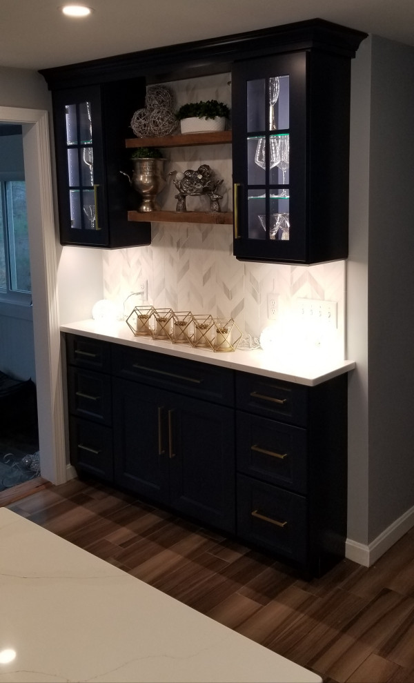 Mid-sized transitional single-wall home bar in Boston with recessed-panel cabinets, blue cabinets, quartz benchtops, multi-coloured splashback, marble splashback and white benchtop.