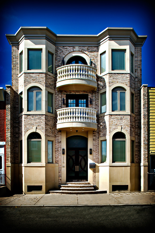 Photo of a traditional three-storey brick beige house exterior in Philadelphia.