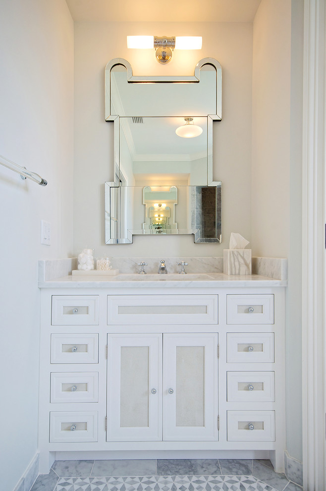 Photo of a beach style bathroom in Jacksonville with white cabinets.