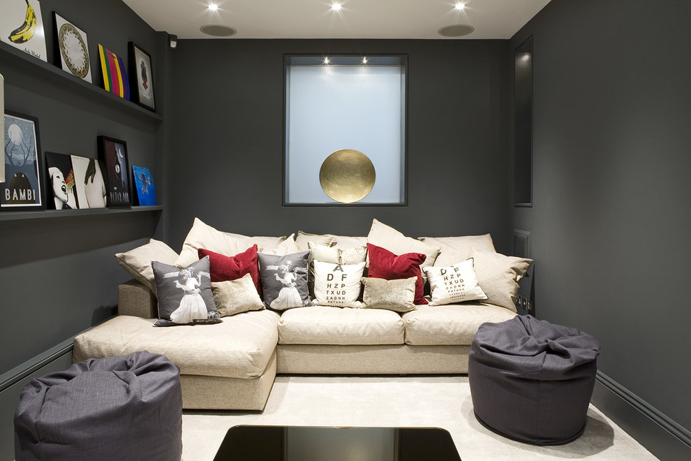 Photo of a small contemporary enclosed home theatre in London with grey walls, carpet and a projector screen.